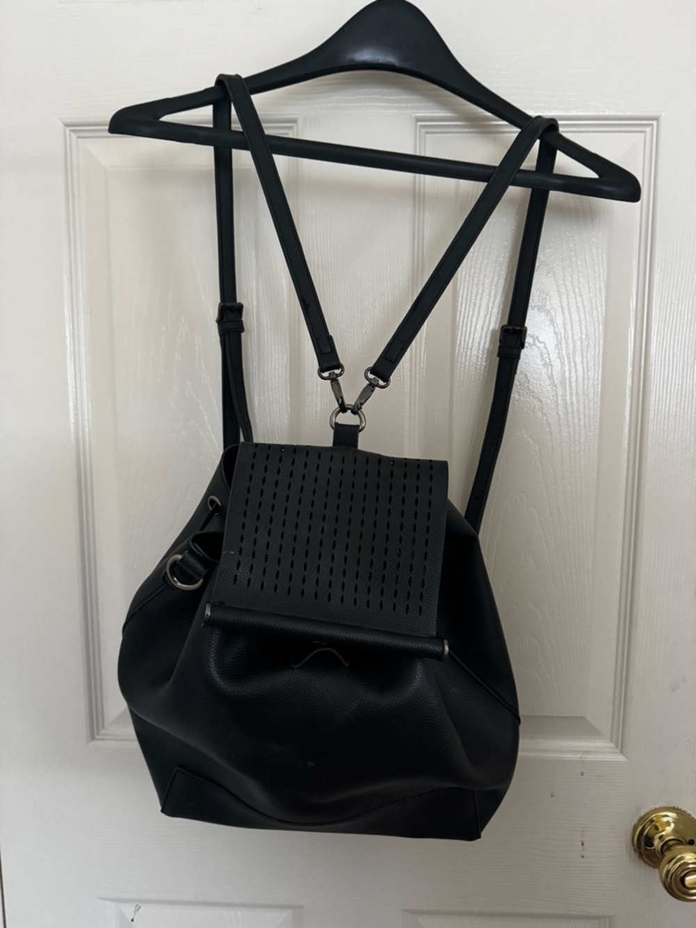 Sleek Black Perforated Flap Backpack